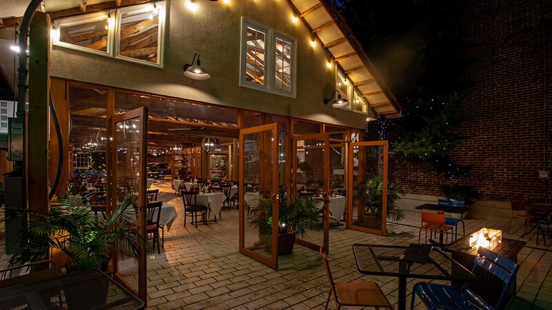 View of covered patio seating area at night