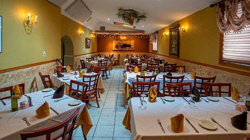 Side dining room with many set tables